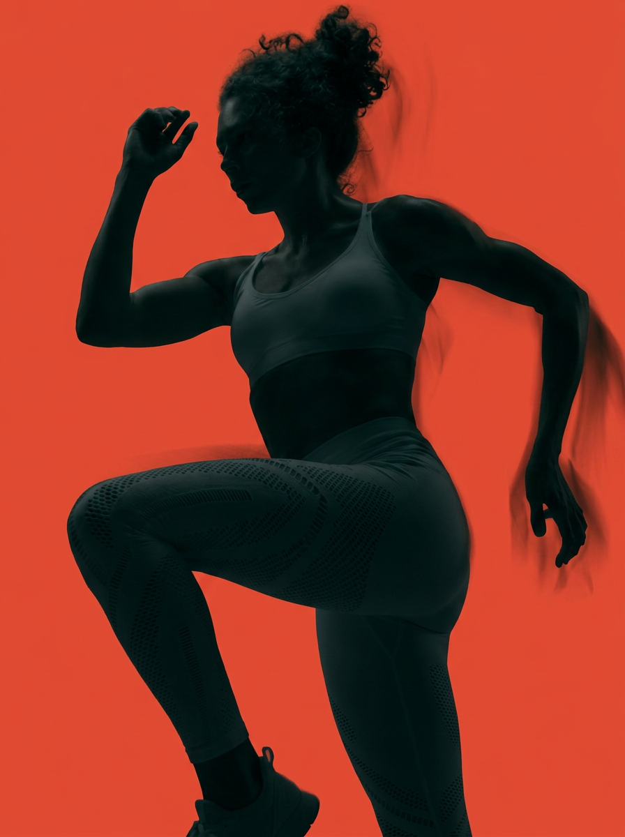 Female athlete in motion under red light